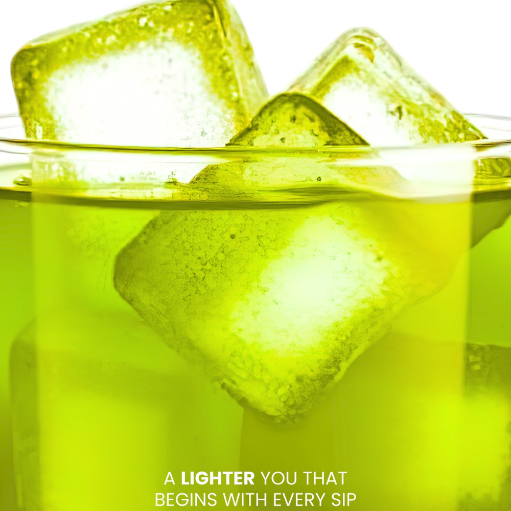 Glass of green liquid with ice cubes on a white background Luna Aura Hope Glow Crystal - Honeydew Green Tea, Dandelion and L-Carnitine Juice Drink
