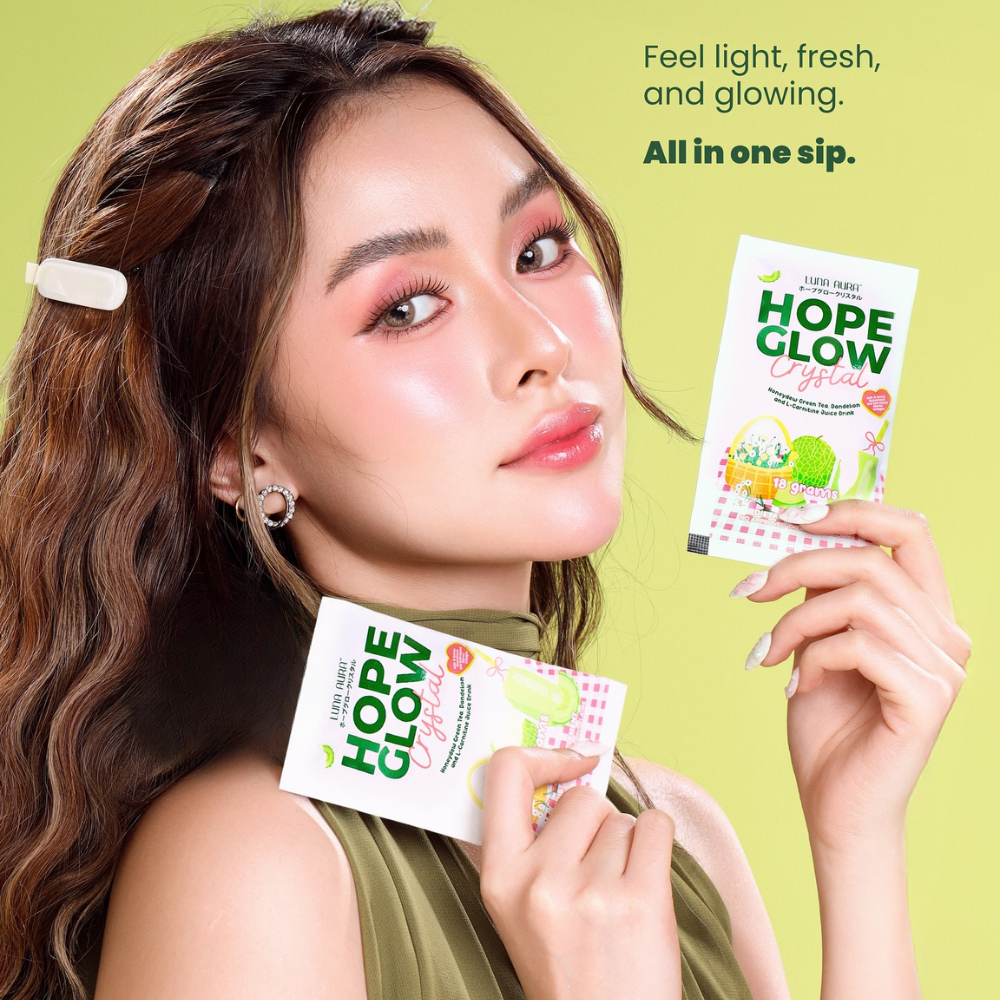 Woman holding 'Hope Glow' drink packets against a green background Luna Aura Hope Glow Crystal - Honeydew Green Tea, Dandelion and L-Carnitine Juice Drink