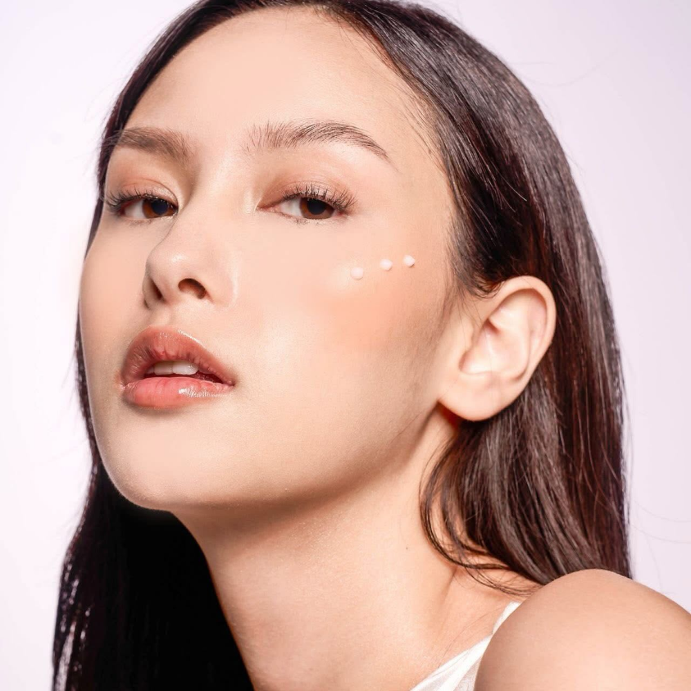 Close-up of a woman with a soft focus on her face against a plain background