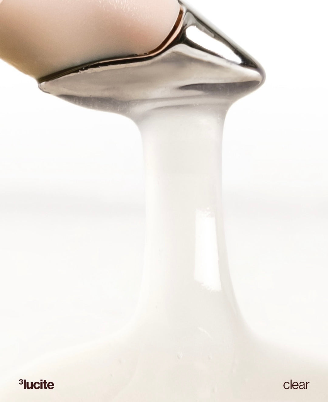 Clear glass vase with metallic base on a white background, featuring the Lucite brand.