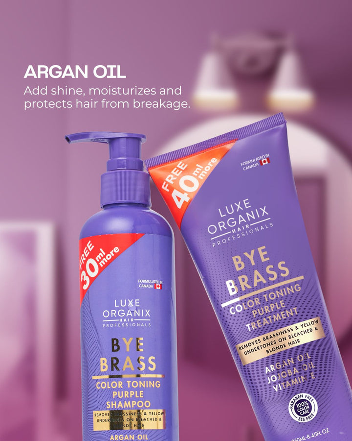 Luxe Organix Bye Brass shampoo and purple treatment on a blurred bathroom background