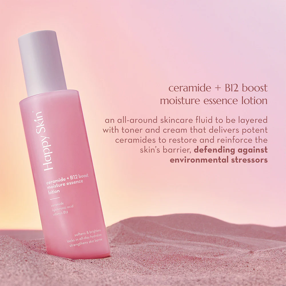 Pink bottle of Happy Skin moisture essence lotion on a pink background with product description text. Happy Skin Ceramide + B12 Boost Moisture Essence Lotion 100ml