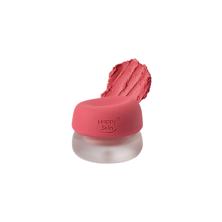 Pink makeup product with 'Happy Skin' branding on a white background