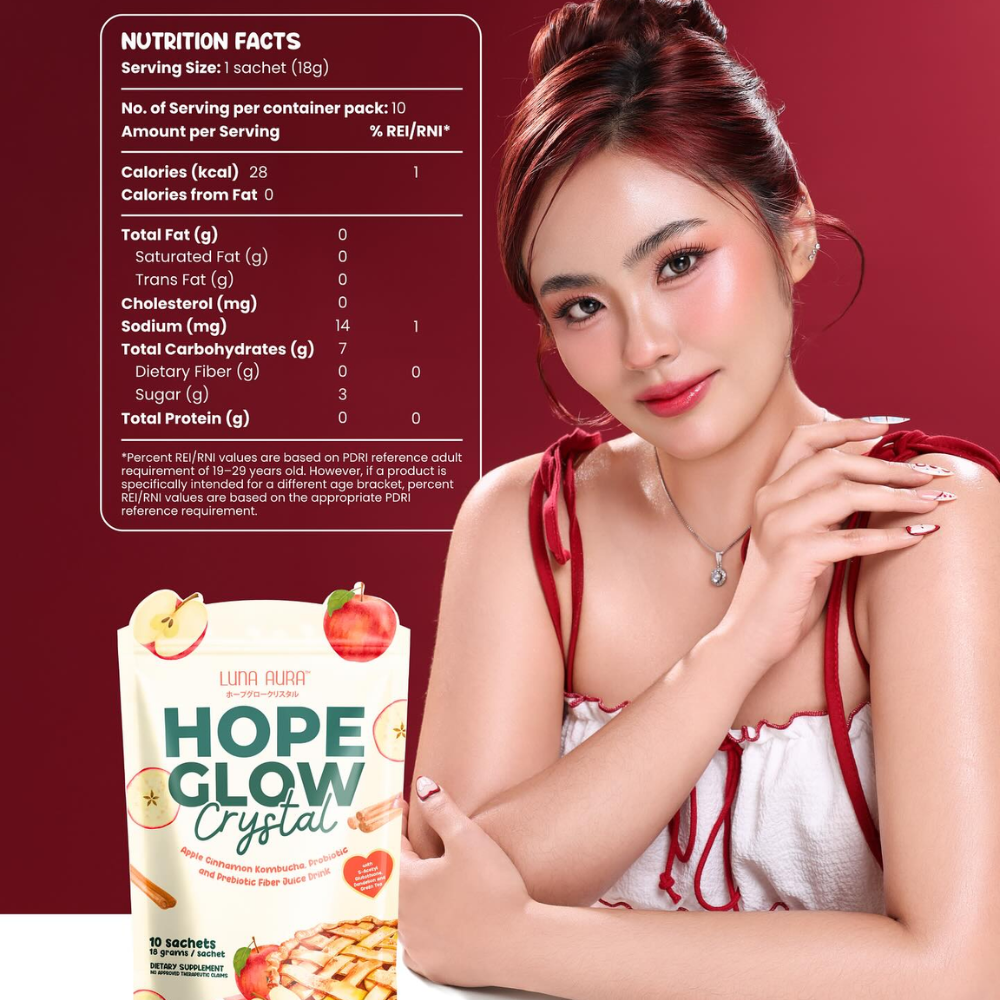 Woman holding a package of 'Hope Glow Crystal' with nutrition facts displayed on a red background Luna Aura Hope Glow Crystal - Apple Cinnamon Kombucha, Probiotic and Prebiotic Fiber Juice Drink