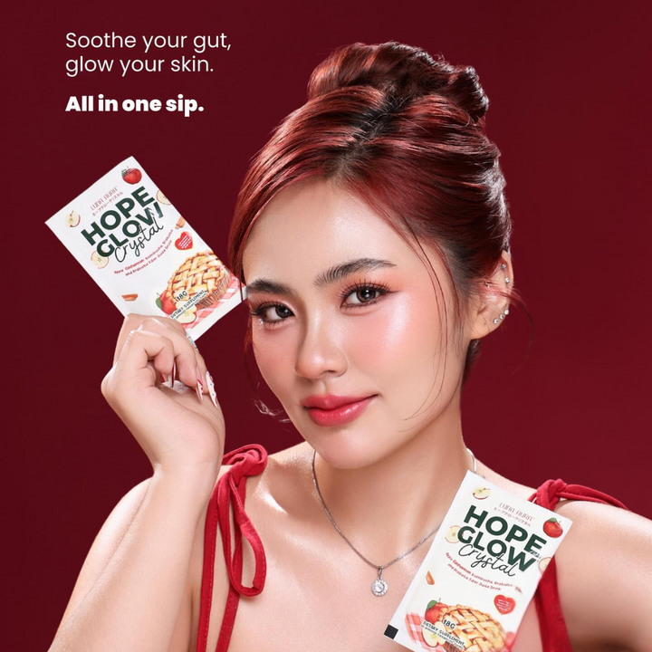 Woman holding 'Hope Glow' products with a red background Luna Aura Hope Glow Crystal - Apple Cinnamon Kombucha, Probiotic and Prebiotic Fiber Juice Drink