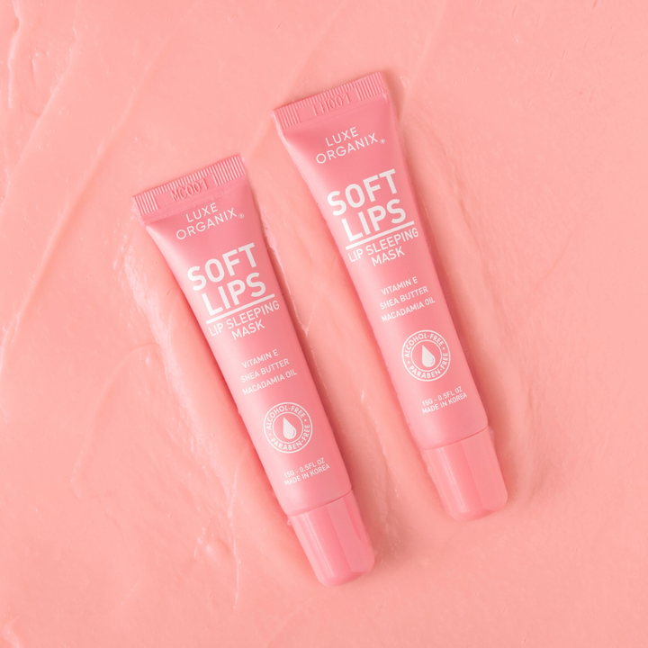 Two pink tubes of Luxe Organix Soft Lips Lip Sleeping Mask on a pink background
