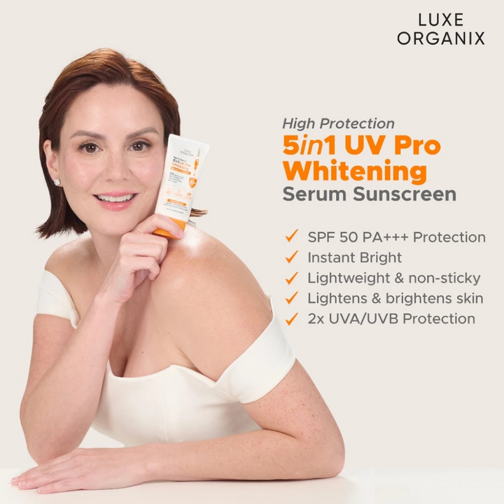 Woman holding Luxe Organix 5in1 UV Pro Whitening Serum Sunscreen with product details on a light background