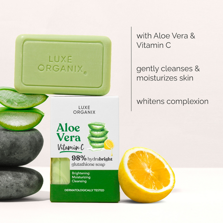 Luxe Organix Aloe Vera Vitamin C soap with packaging, aloe vera leaves, and lemon on a white background.
