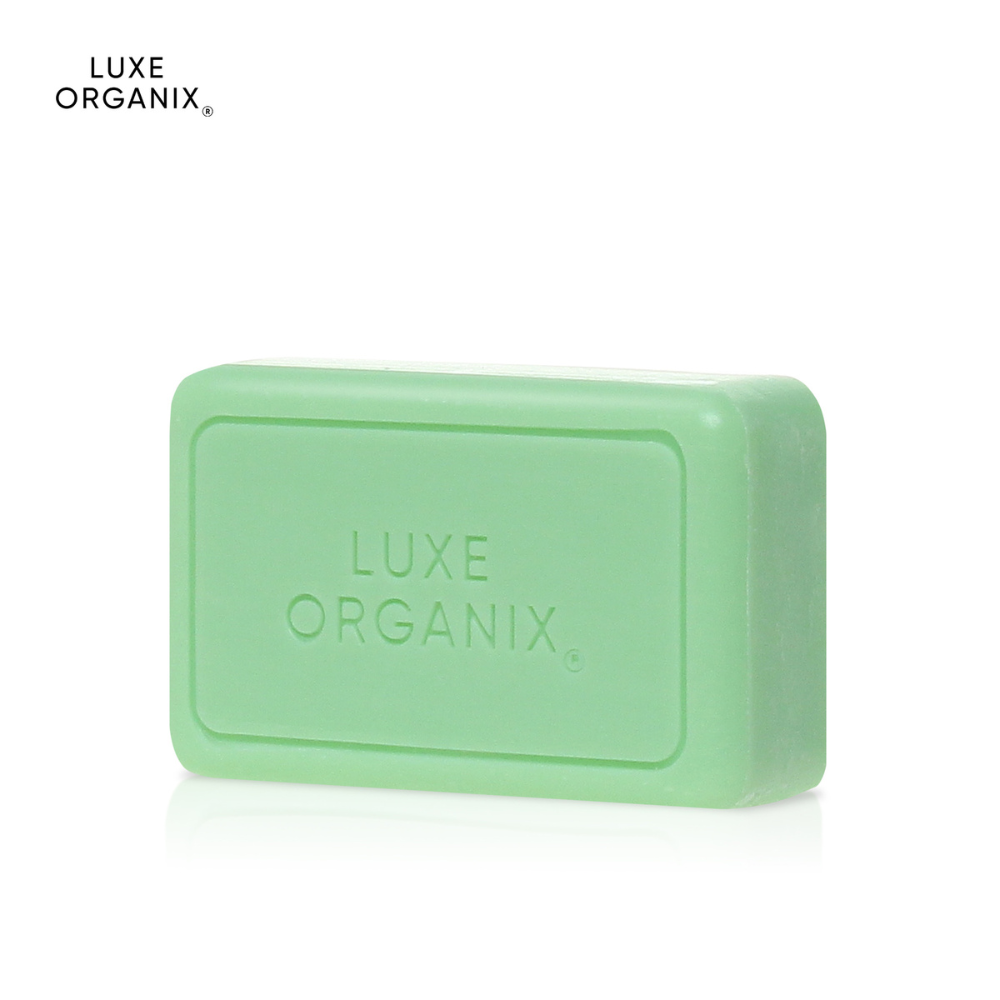 Green bar of soap with 'LUXE ORGANIX' branding on a white background