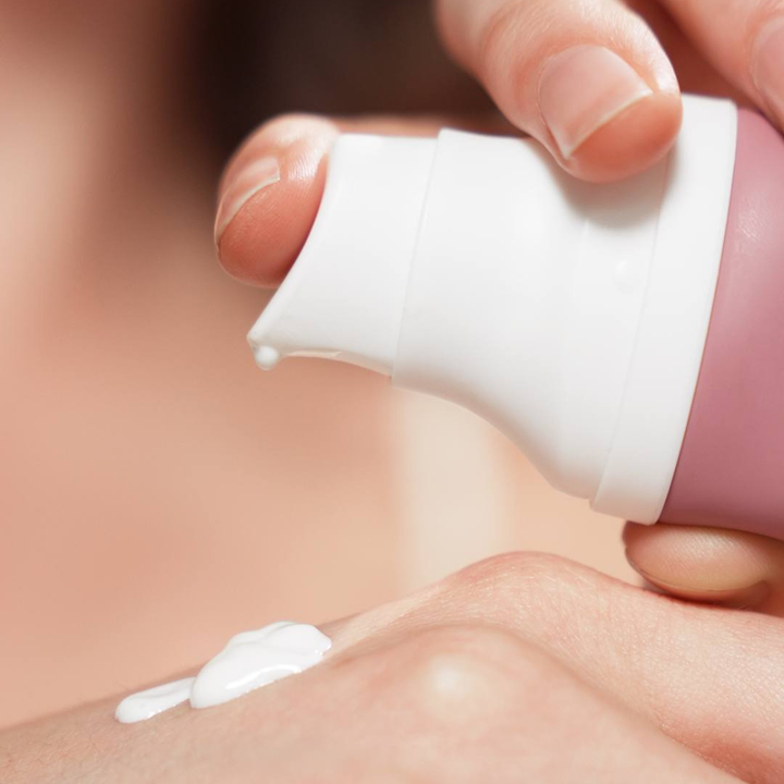 Luxelle Centella Sun Serum SPF PA 50+++ Hand applying cream to skin with a small applicator