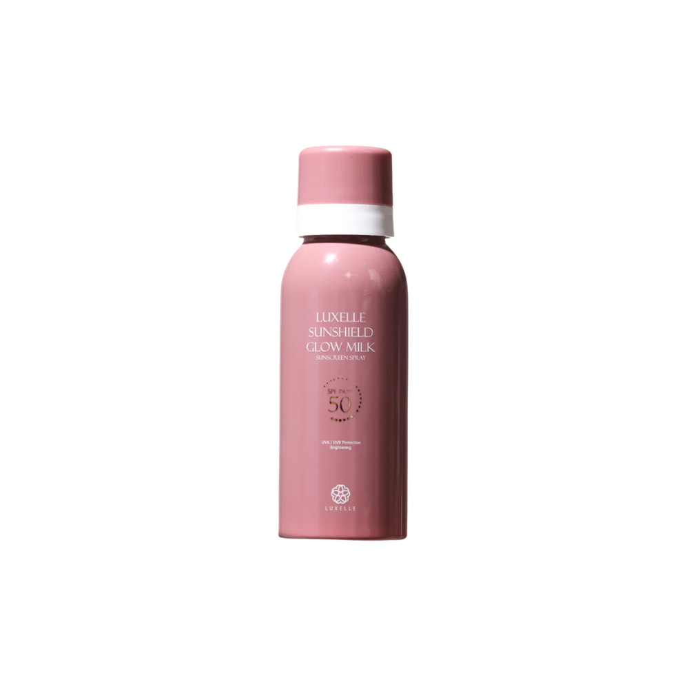 Pink sunscreen bottle with white cap on a white background Luxelle Sunshield Glow Milk Sunscreen Spray