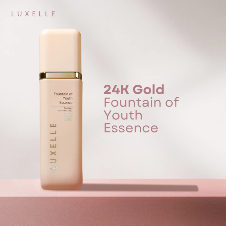 Luxelle 24K Gold Fountain of Youth Essence bottle on a light pink background