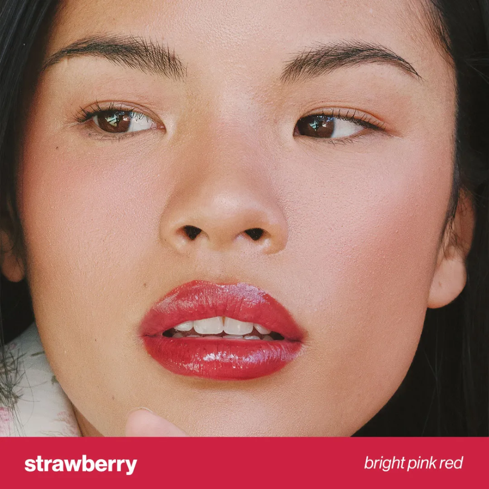 Close-up of lips wearing Juice Tint -Strawberry by Sunnies Face in a bright pink red glossy tint