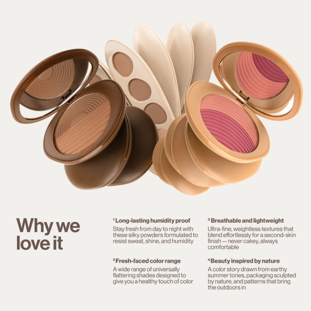 Makeup products including a bronzer, blush, and eyeshadow palette on a light background.