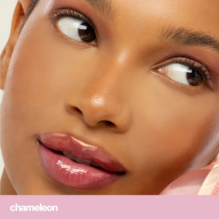Close-up of a woman's face with a focus on her eyes and lips, featuring the brand 'Chameleon'. Sunnies Face Lip Glaze - a peptide lip treatment