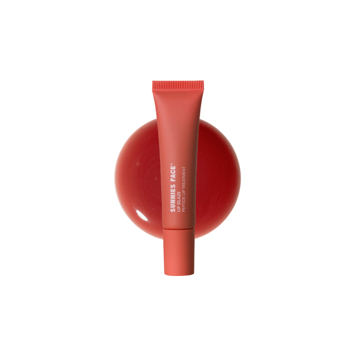 Red lip balm tube on a white background Sunnies Face Lip Glaze - a peptide lip treatment