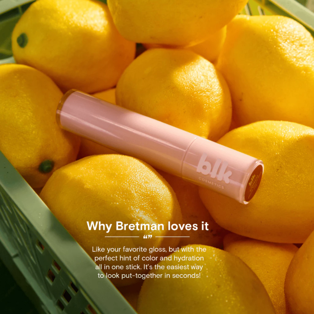 Pink lip gloss on lemons with text about a product feature blk cosmetics Glossy Serum Stick
